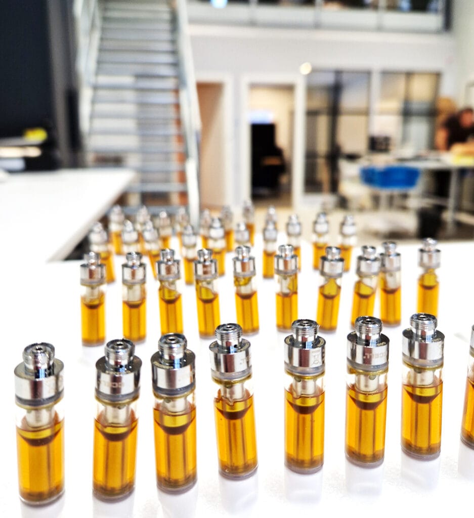 Freshly filled CBD vape cartridges lined up in the Raw Hemp production