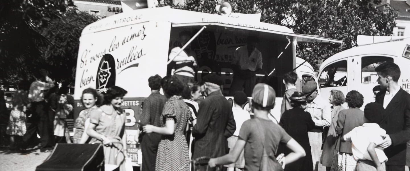 Historic photo of an OCB van and people in France