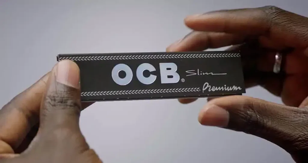 Hand holding a pack of OCB Premium Slim