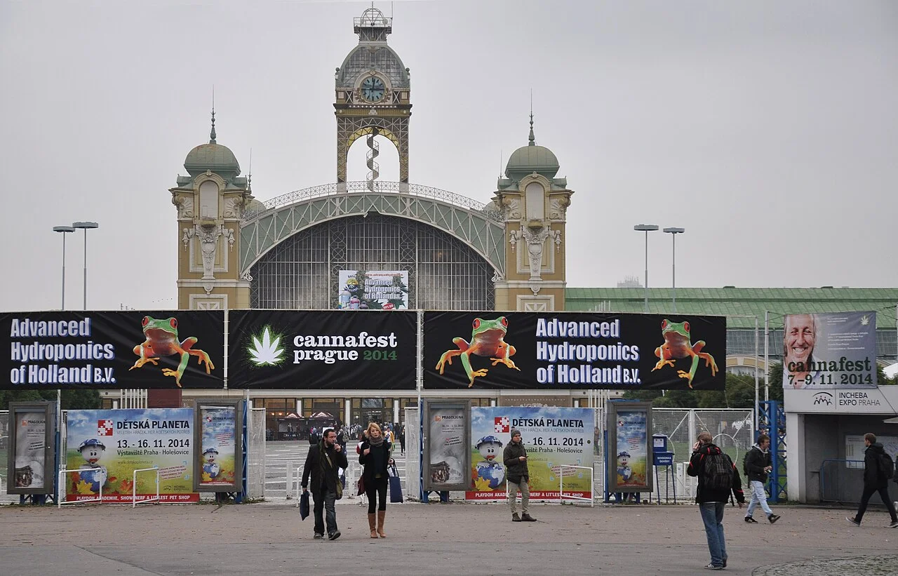 Visitors outside the Industrial Palace at Výstaviště in Prague with Cannafest banners